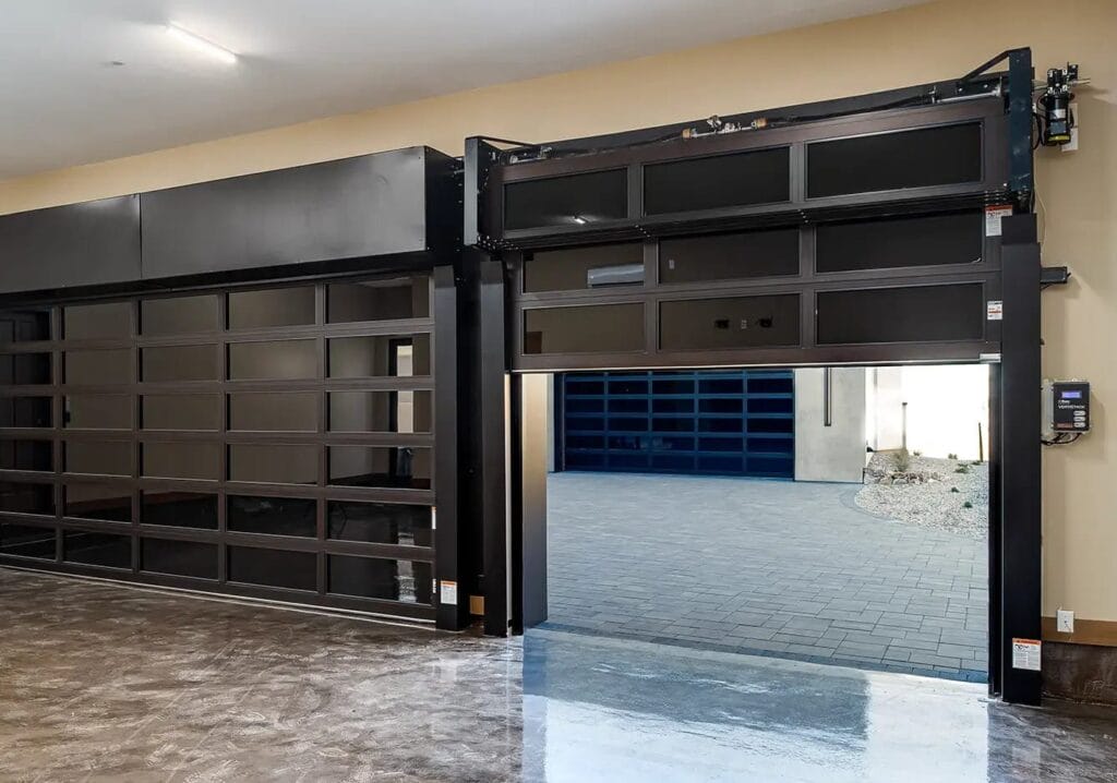 A modern garage with one glass door closed and the other partially raised, showing how a garage door closes then opens abruptly.