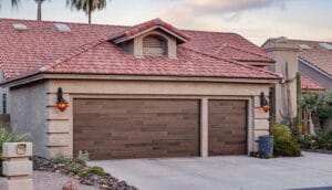 A large wood-finish garage door on a southwestern home that can still experience everyday garage door issues.